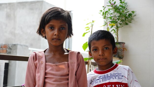 Poor siblings together outdoor image