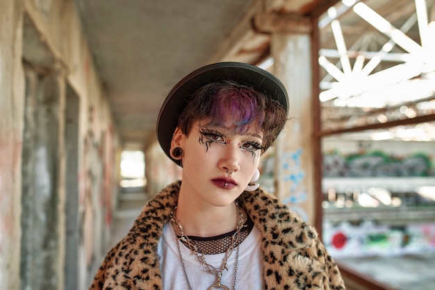 Pop punk aesthetic portrait of woman posing inside building