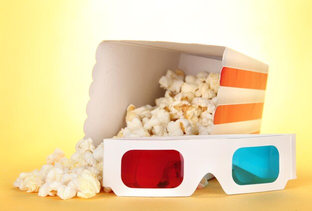 Photo popcorn and 3d glasses on yellow background