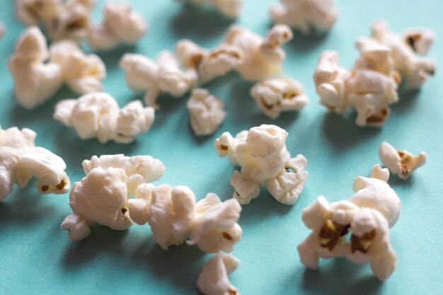 Popcorn on blue pastel background. movie snack. top view