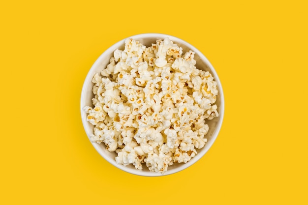 Popcorn in una ciotola su sfondo giallo