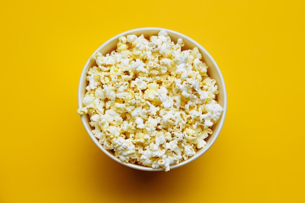 Popcorn in a bowl on yellow