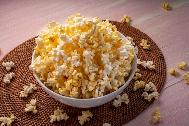 Popcorn in bown on wooden background Popcorn in bowl on wooden table