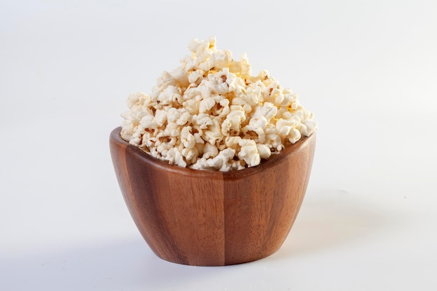 Popcorn in brown bowl on white background