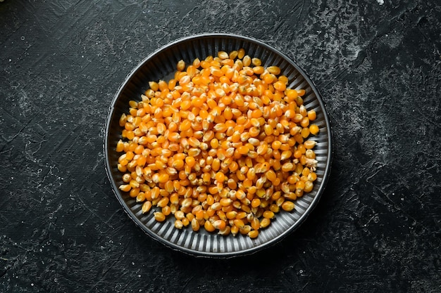 Popcorn and corn for popcorn on kitchen table Top view