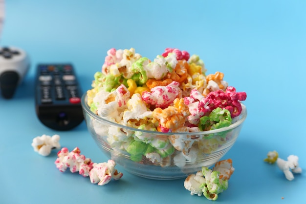 Popcorn en tv-afstandsbediening op blauw