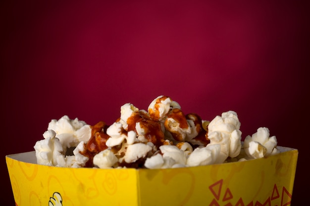 Popcorn isolated in red background