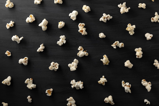 Popcorn lined up in pattern on a black background