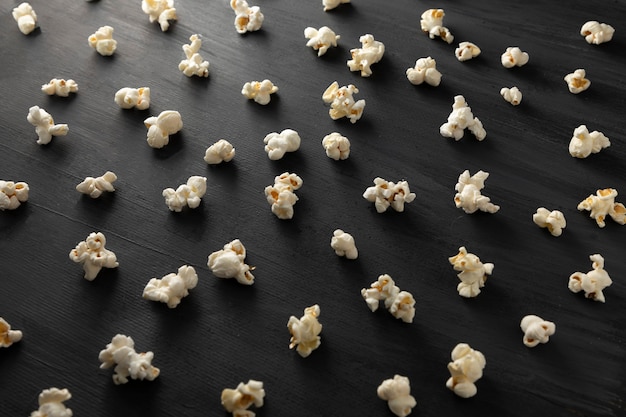 Popcorn lined up in pattern on a black background