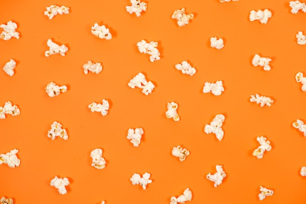 Popcorn on an orange background closeup view from above