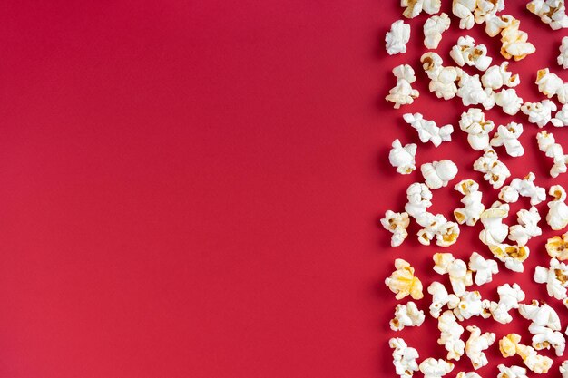 Popcorn pattern border on red background top view flat lay with copy space