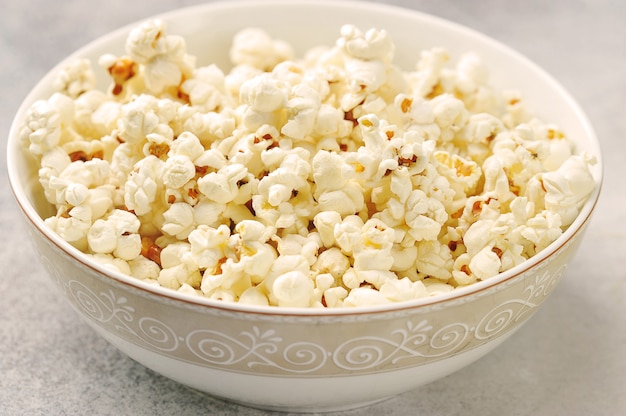 Popcorn in a plate on a gray