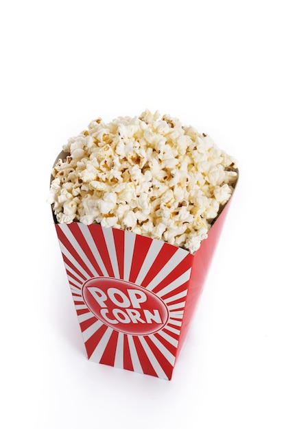 Popcorn in red and white striped cardboard bucket isolated on white background