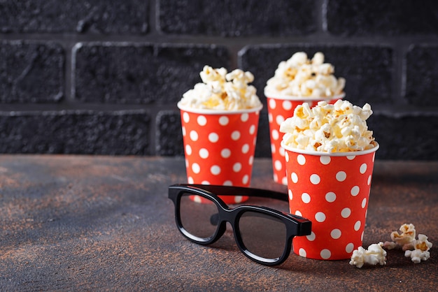 Popcorn with 3d glasses on dark background