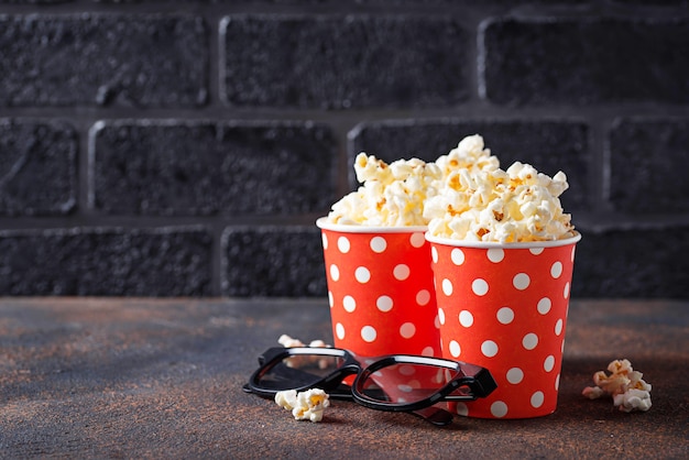 Popcorn with 3d glasses on dark background