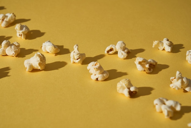 Popcorn on a yellow background Copy space Pop corn collection Different sizes of popcorn