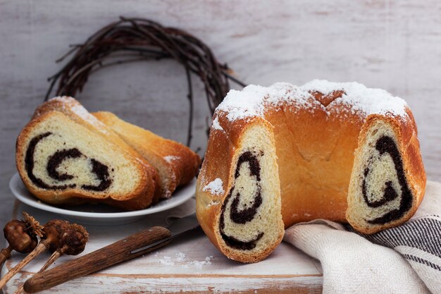 Poppy seed cake made from yeast dough and coffee on a light background