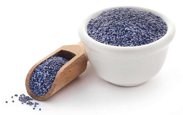 Poppy seeds in a bowl with wooden scoop over white background