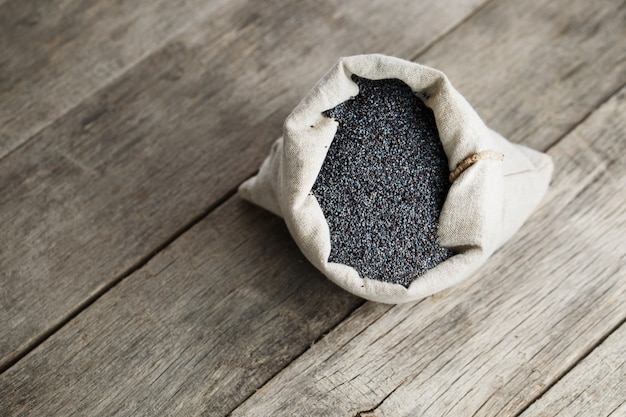 Poppy seeds in a burlap bag. The tasty and useful seeds rich with protein and oils.