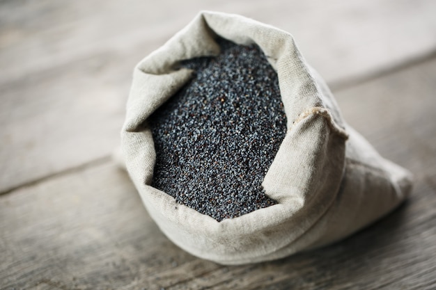 Poppy seeds in a burlap bag. The tasty and useful seeds rich with protein and oils.