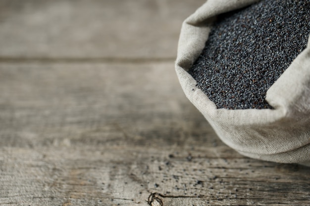 Poppy seeds in a burlap bag. The tasty and useful seeds rich with protein and oils.