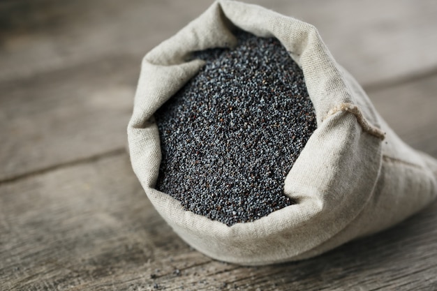 Poppy seeds in a burlap bag. The tasty and useful seeds rich with protein and oils.