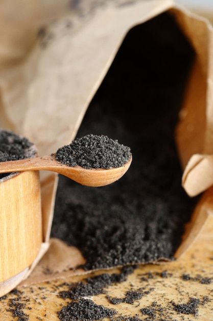 Poppy seeds with poppy flour on wooden table Coeliac disease concept