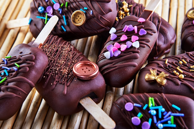 Pops cake in the form of chocolate ice cream with decoration. Close up