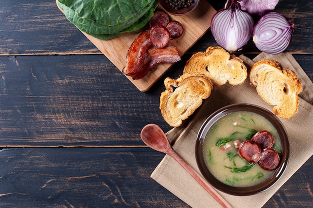 Popular dish of Portuguese cuisine called Caldo Verde made with potatoes, bacon, pepperoni sausage and kale