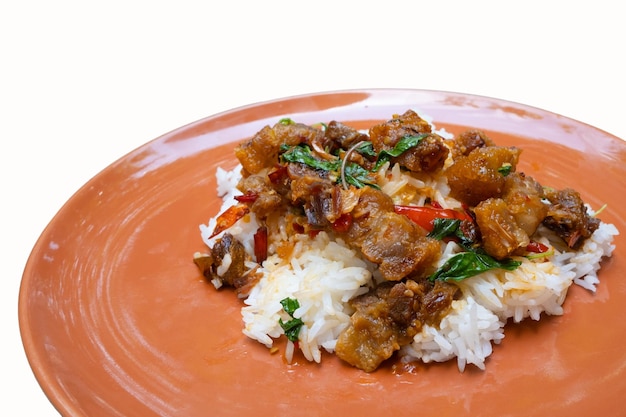 Popular street food or homemade of thailand crispy pork belly\
stir fried basil on rice isolated