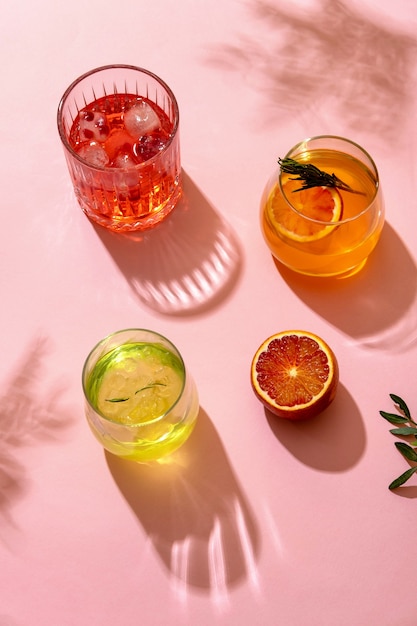 Popular summer ice alcoholic cocktails served under the summer sun light, view from above. Trendy retro style with shadows.