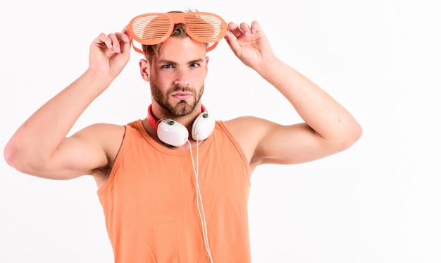 Popular summer track list Technology and entertainment Modern life Summer music chart Handsome man with headphones and sunglasses Guy unshaven face listening summer music Party concept Dj boy