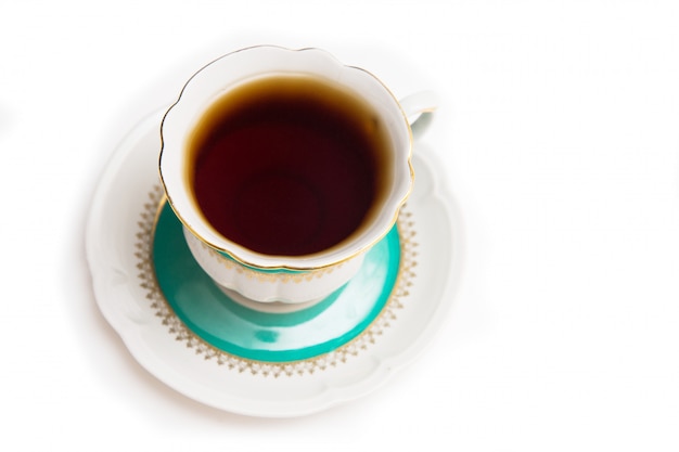 Porcelain cup of tea on a white background