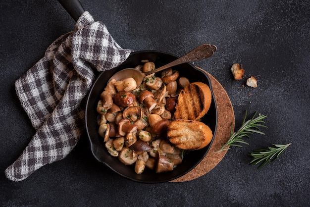 Porcini mushrooms cooked in a frying pan with grilled bread