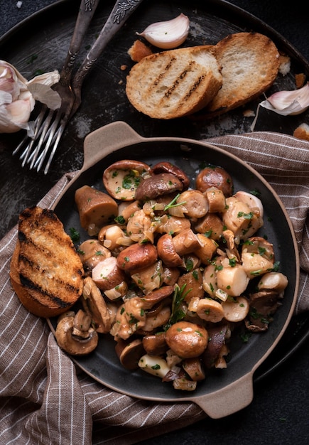 Photo porcini mushrooms cooked in a frying pan with grilled bread