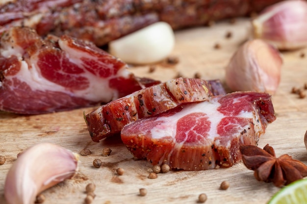 Pork and bacon sliced during cooking dried meat cut into pieces on a cutting board