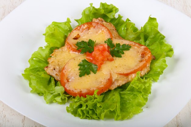 Pork baked with tomato and cheese