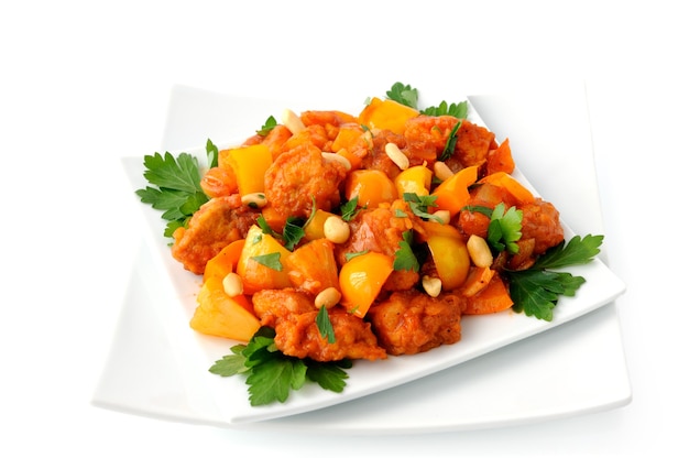 Pork in batter with pineapple and bell pepper in sweet and sour sauce with peanuts