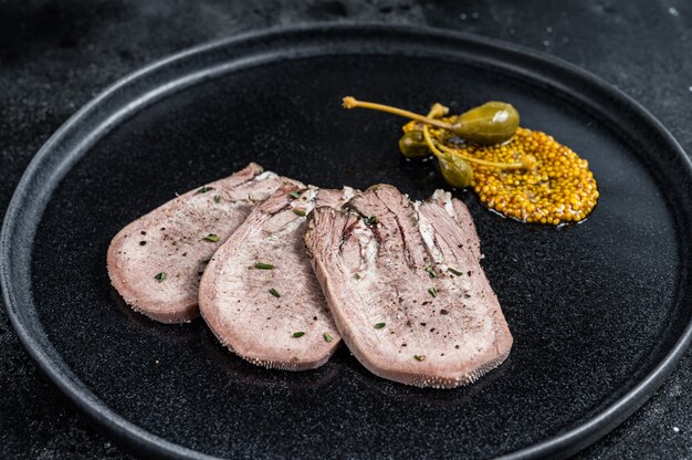 Pork boiled tongue slices on a plate