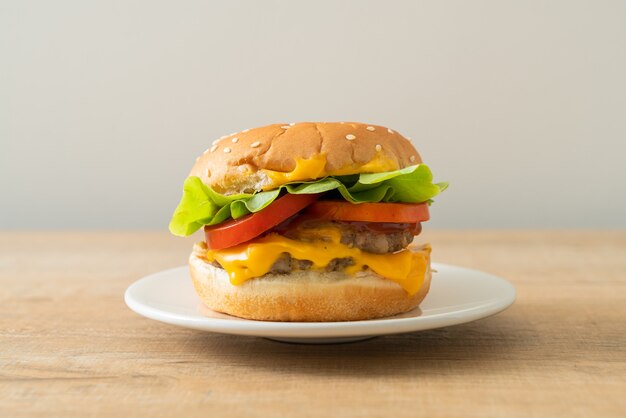 pork burger with cheese on white plate