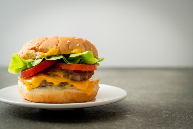 pork burger with cheese on white plate