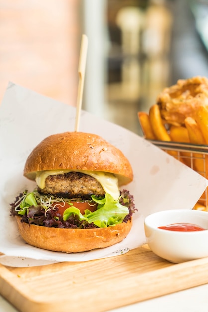 pork burger with onion rings and french fries