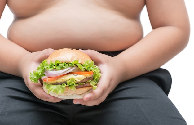 Formaggio di maiale hamburger in mano di ragazzo grasso obeso