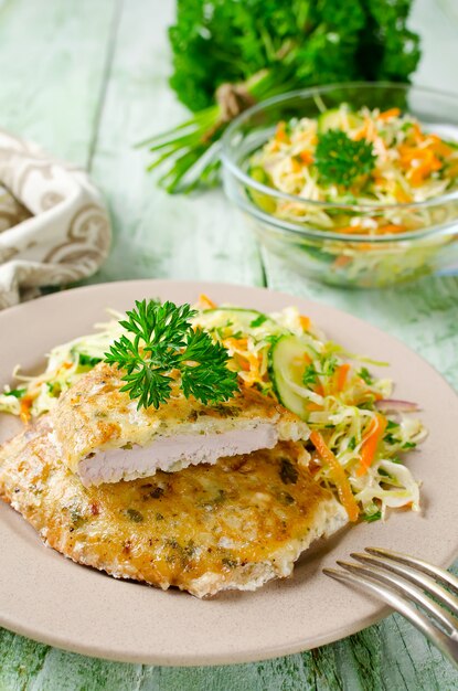 Photo pork chop in batter with vegetable salad