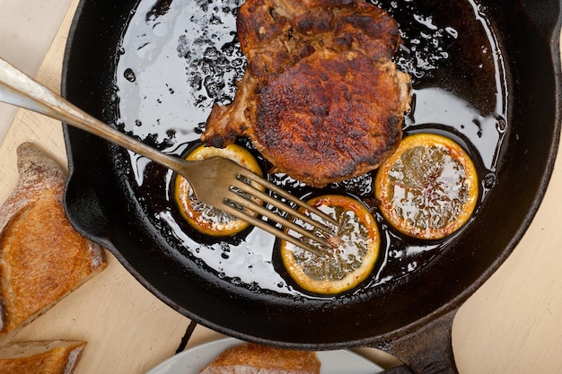 Pork chop seared on iron skillet