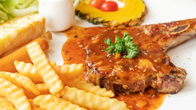 Pork Chop steak on a white plate.