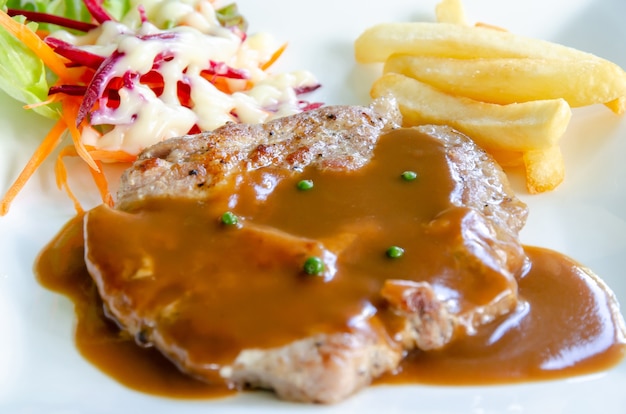 Pork chop steak with brown gravy sauce