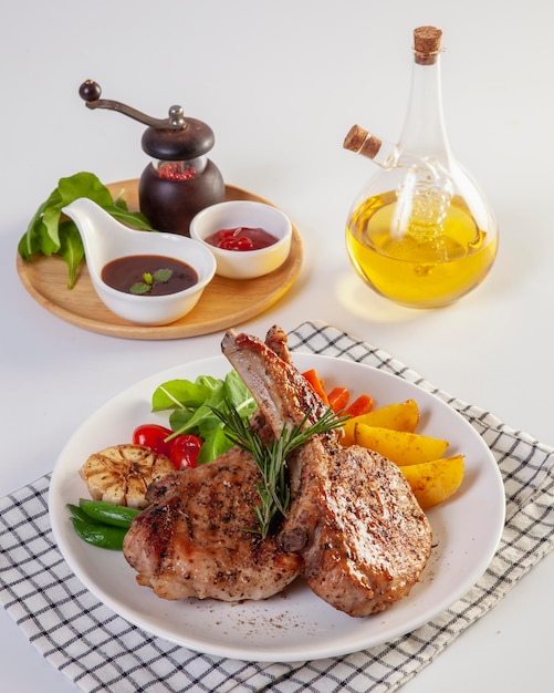 Pork chop with vegetable in plate