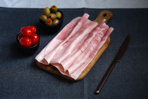 Pork ham slices on a wooden board