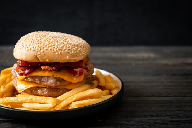 pork hamburger or pork burger with cheese, bacon and french fries